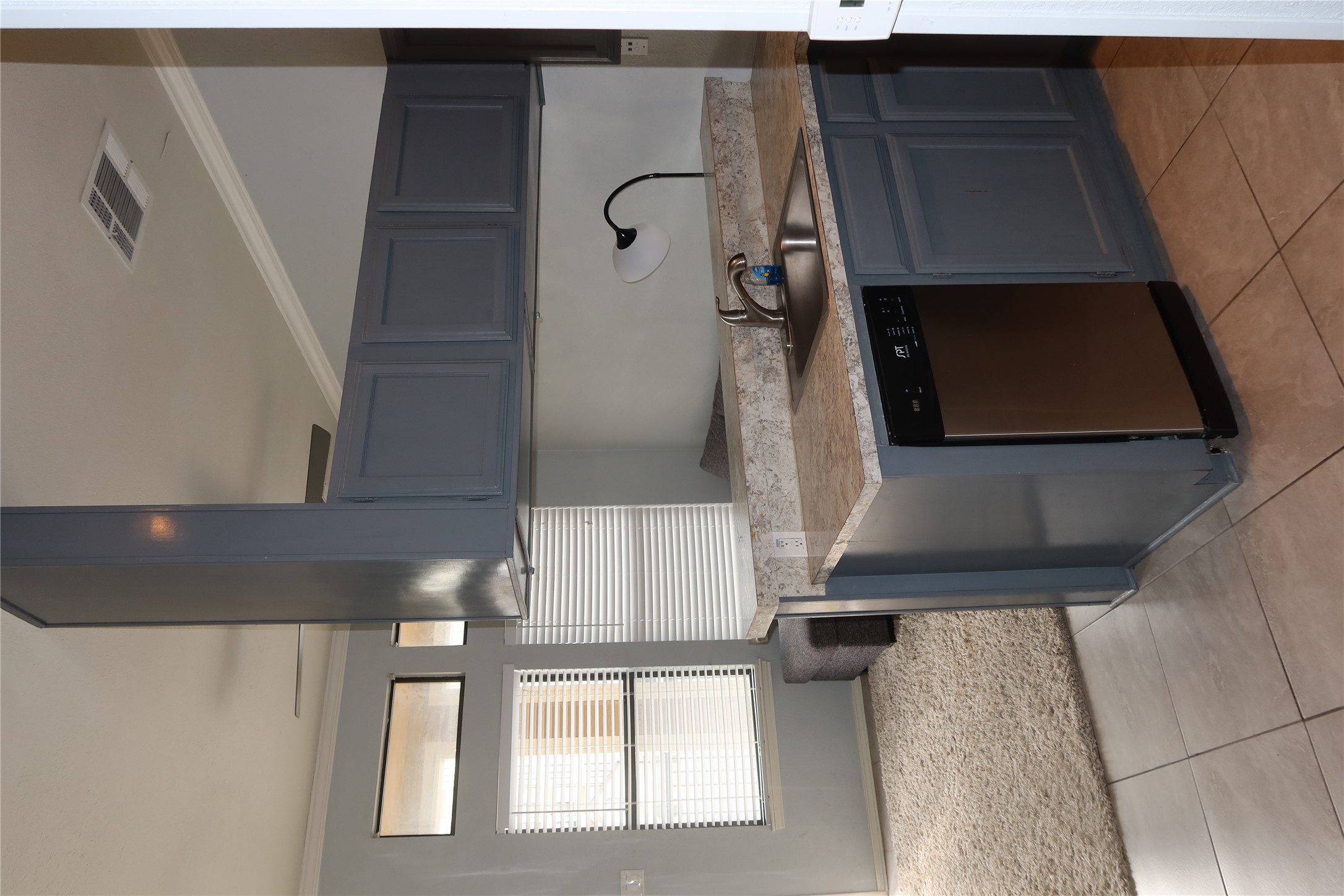 2802 Nueces Street, Unit 306 Austin, TX 78705 - Photo 6 of 20 Kitchen featuring a stainless steel dishwasher, a single-basin sink with a chrome faucet, and a light-toned countertop