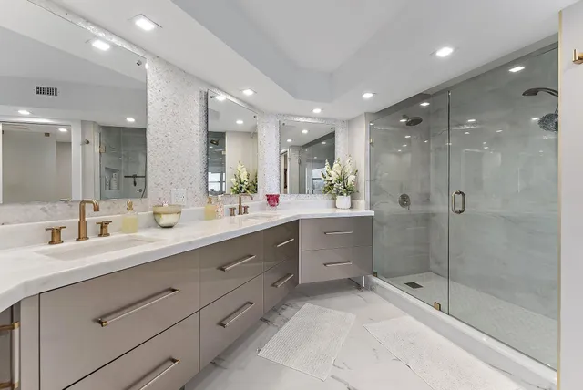 a bathroom with a shower sink double vanity and a mirror