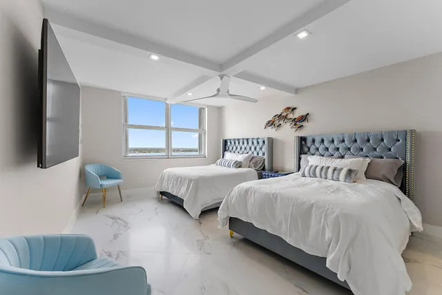 a spacious bedroom with two beds and a couch