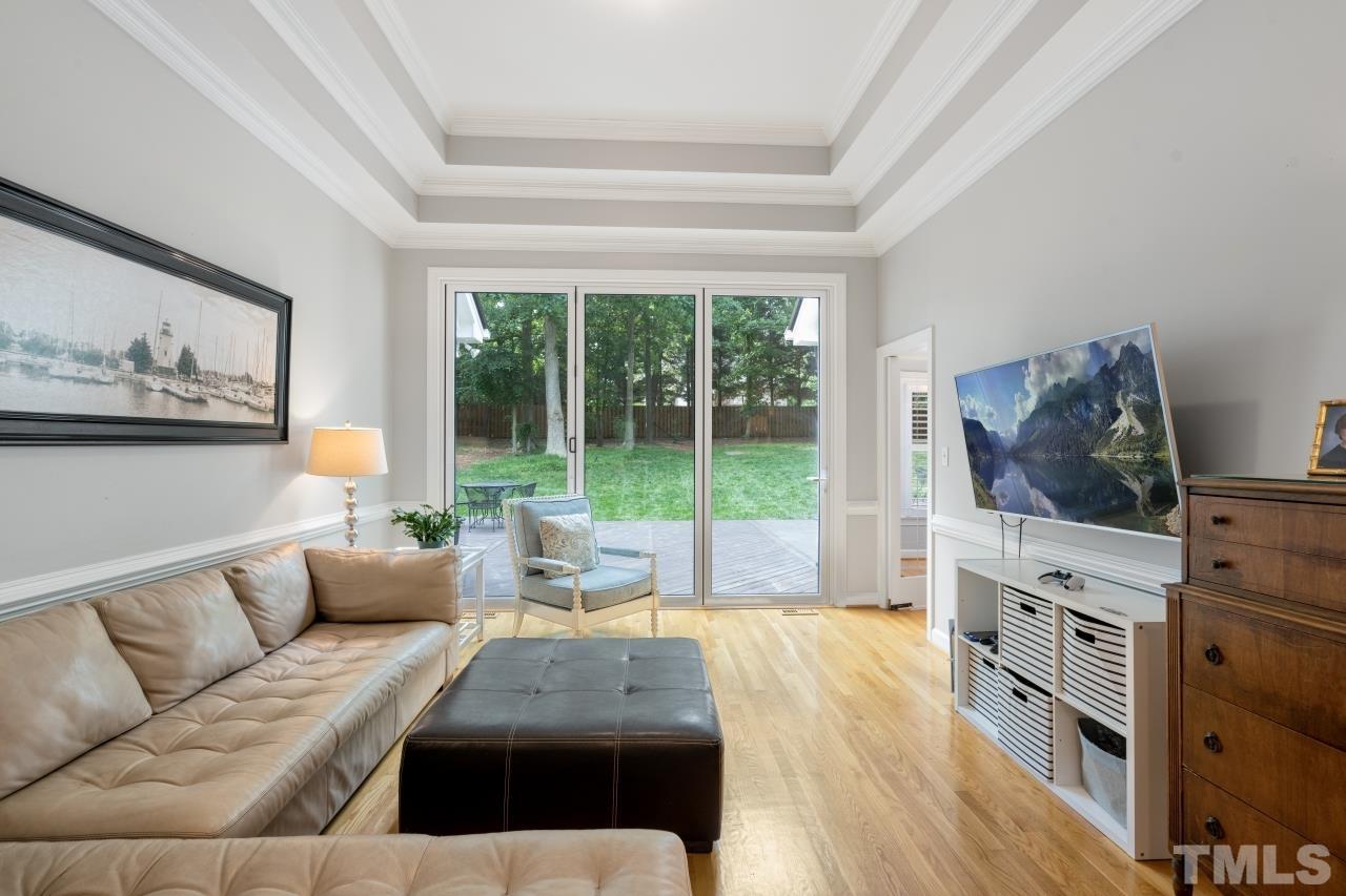 4401 Touchstone Forest Road Raleigh, NC 27612 - Photo 11 of 44 a living room with furniture and a flat screen tv