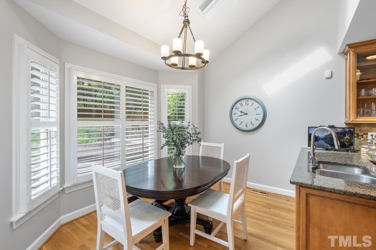 4401 Touchstone Forest Road Raleigh, NC 27612 - Photo 18 of 44 a dining room with a large window table and chairs