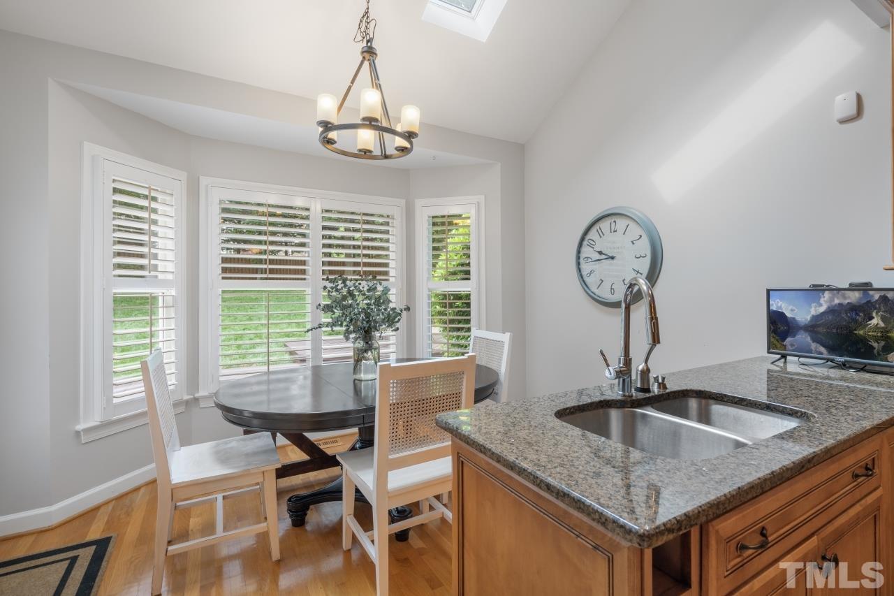 4401 Touchstone Forest Road Raleigh, NC 27612 - Photo 19 of 44 a view of a dining room with furniture window and wooden floor