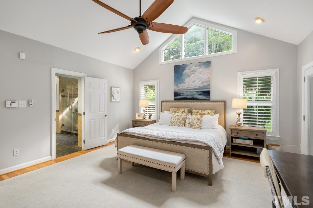 4401 Touchstone Forest Road Raleigh, NC 27612 - Photo 21 of 44 a bedroom with a bed and a chandelier