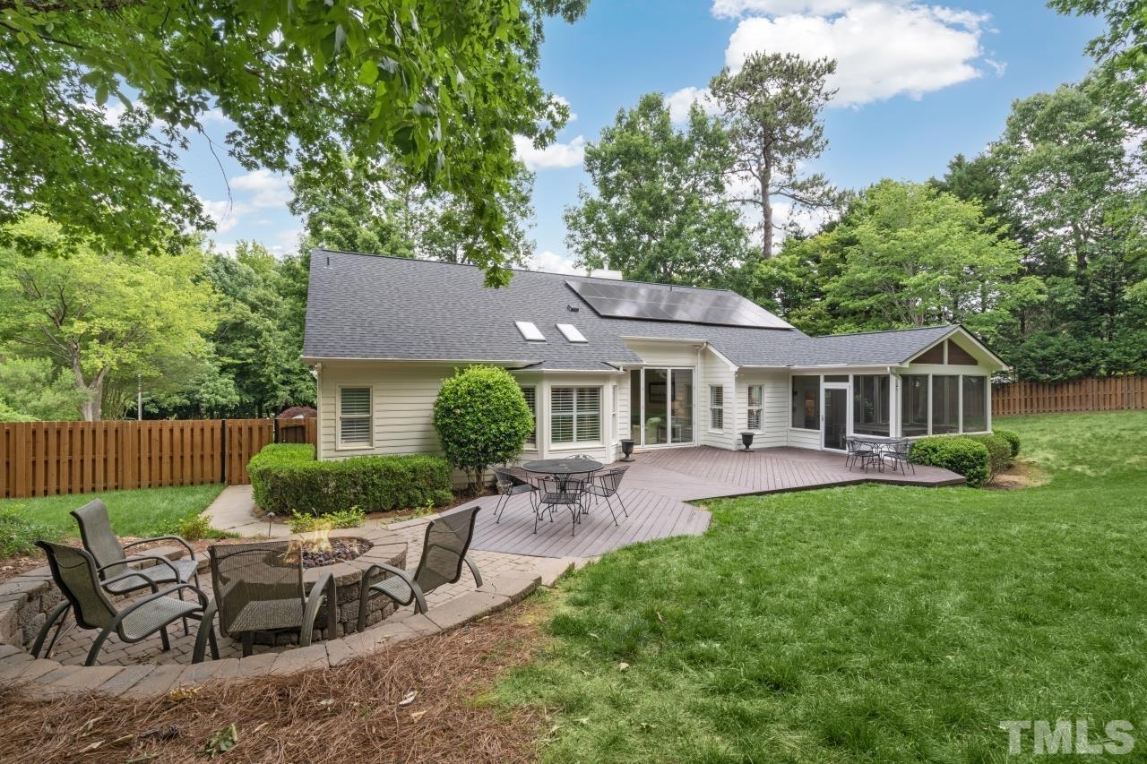 4401 Touchstone Forest Road Raleigh, NC 27612 - Photo 35 of 44 a view of a patio with table and chairs potted plants and a large tree