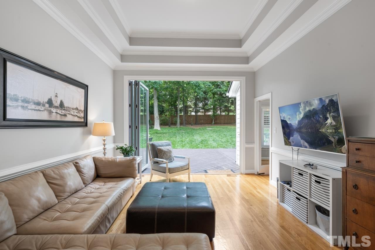 4401 Touchstone Forest Road Raleigh, NC 27612 - Photo 9 of 44 a living room with furniture and a flat screen tv