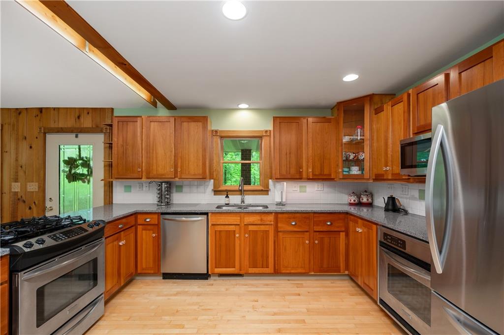 223 Cashdollar Road Mars, PA 16046 - Photo 19 of 42 a large kitchen with stainless steel appliances granite countertop a stove a sink dishwasher and a refrigerator