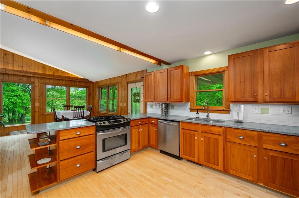 223 Cashdollar Road Mars, PA 16046 - Photo 20 of 42 a kitchen with stainless steel appliances granite countertop a stove a sink dishwasher and a microwave oven with granite countertops