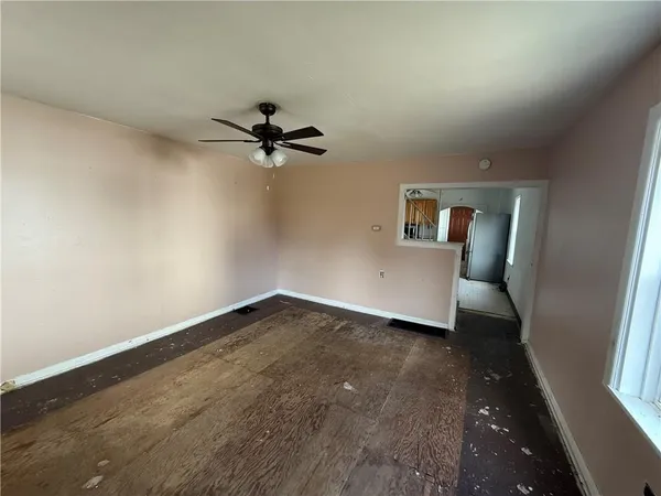 wooden floor in an empty room with a window