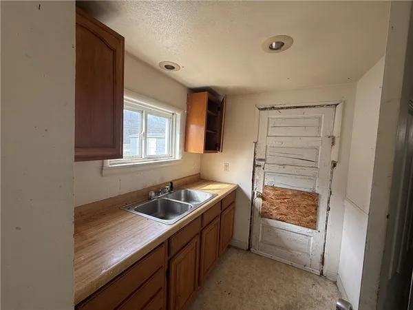 a kitchen that has a sink and a stove in it
