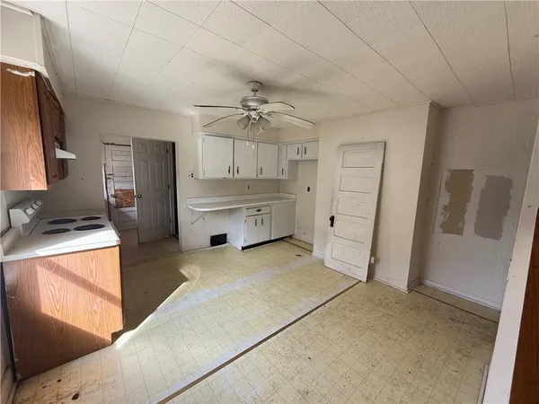 a room with a stove and a refrigerator