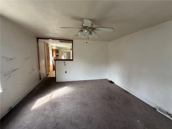 an empty room with a empty space and windows