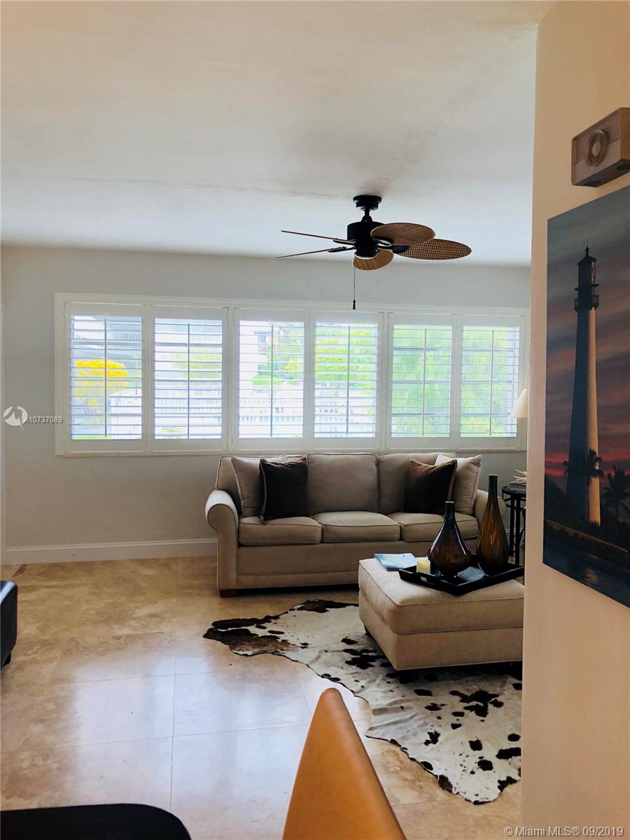 201 Sunrise Drive, Unit 109 Key Biscayne, FL 33149 - Photo 4 of 14 a living room with furniture and a large window