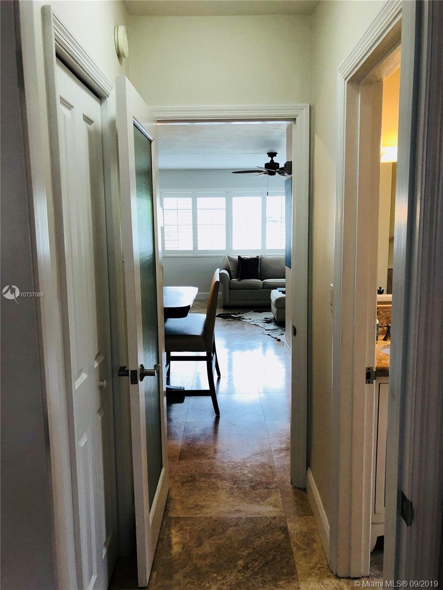 201 Sunrise Drive, Unit 109 Key Biscayne, FL 33149 - Photo 10 of 14 a view of a hallway with furniture and a window