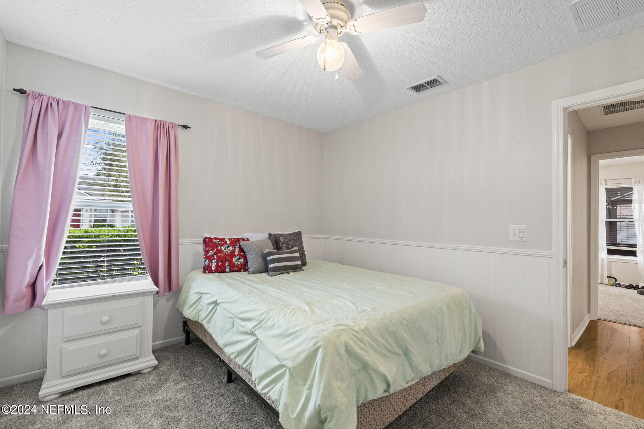 4301 Rye Court St. Johns, FL 32259 - Photo 29 of 47 a bedroom with a bed and a chandelier