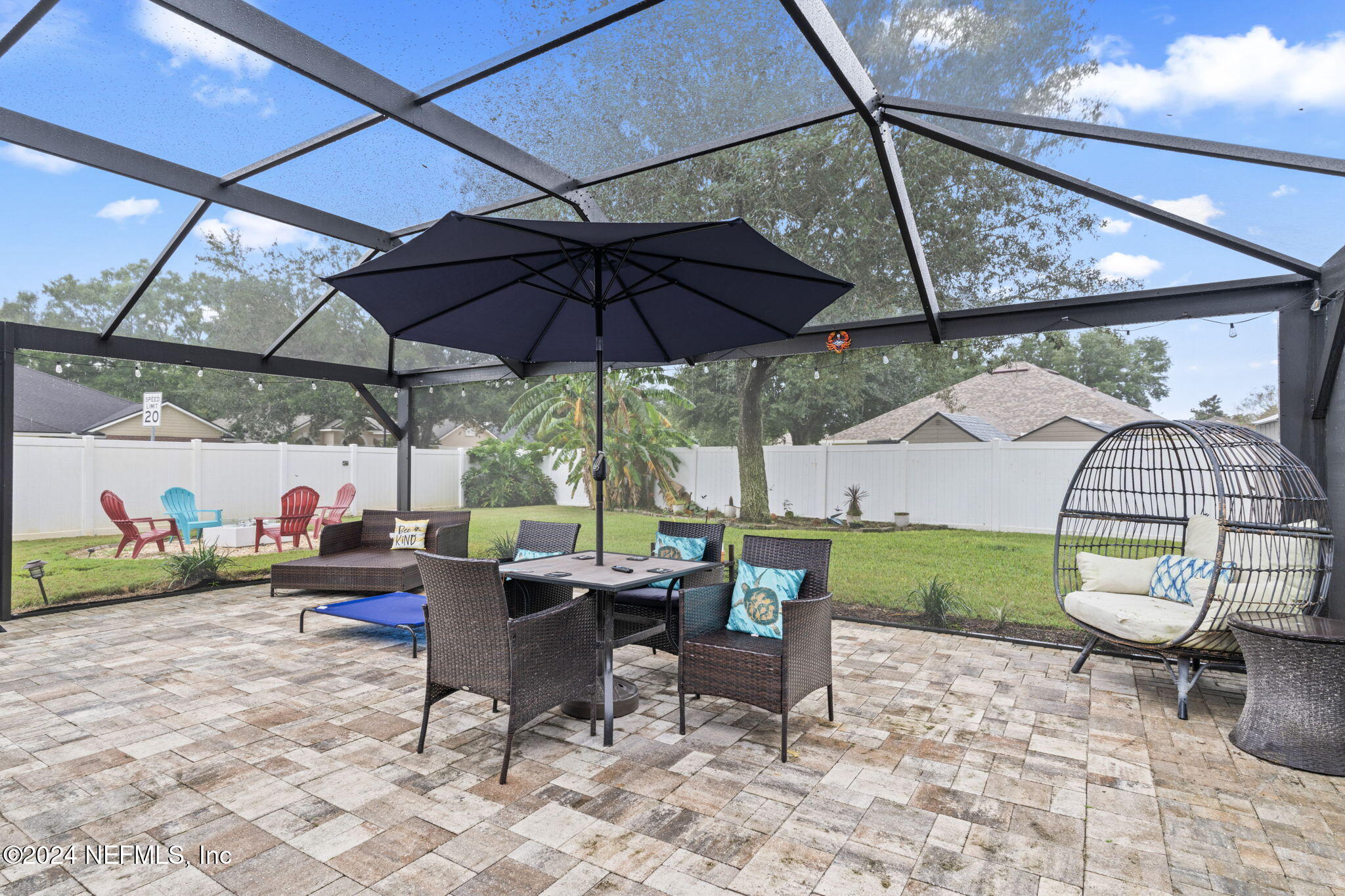 4301 Rye Court St. Johns, FL 32259 - Photo 33 of 47 a view of a patio with a table and chairs under an umbrella