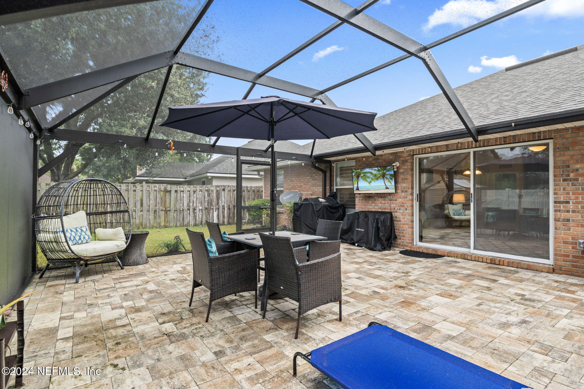 4301 Rye Court St. Johns, FL 32259 - Photo 35 of 47 a view of a patio with a dining table and chairs under an umbrella