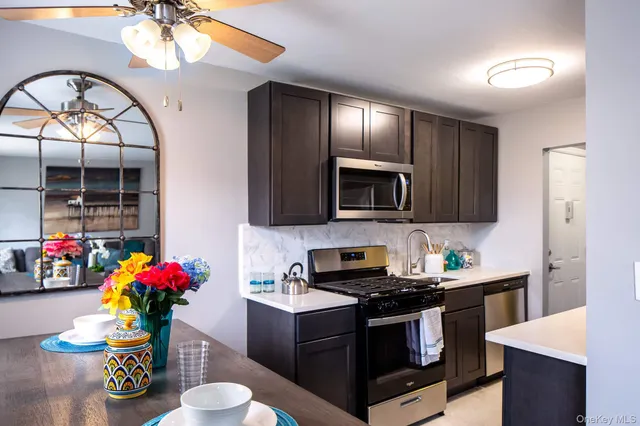 a kitchen with a sink stove and microwave