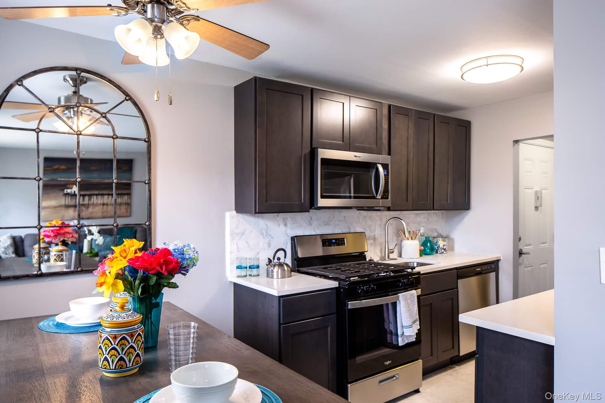 a kitchen with a sink stove and microwave