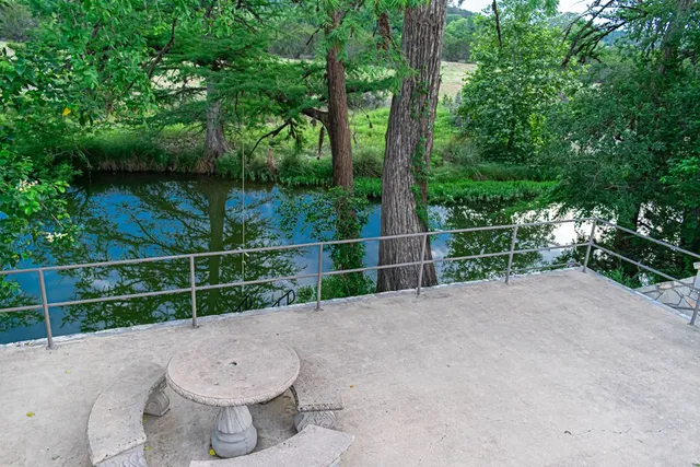a view of a backyard with a pot and a tree