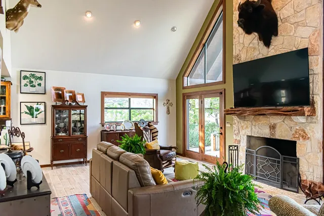 a living room with furniture a flat screen tv and a fireplace