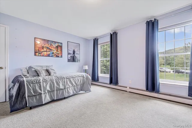 a bed room with a bed and a large window