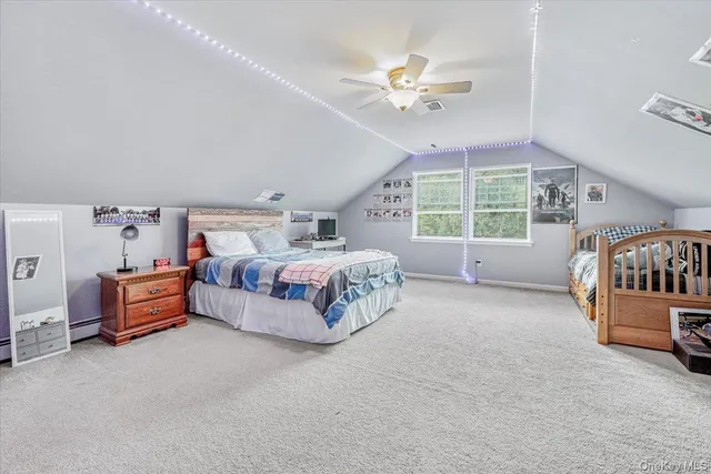 a spacious bedroom with a bed and a chandelier