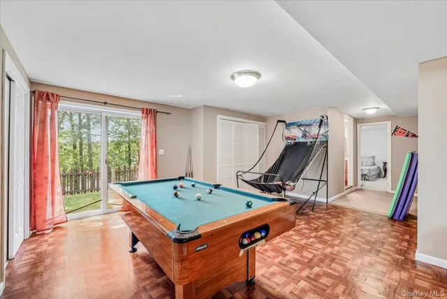 a room with table chairs and wooden floor