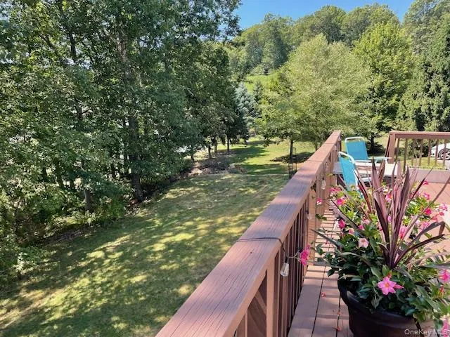 a view of a house with a yard and deck