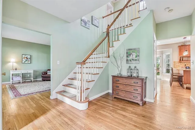 a view of entryway livingroom and hall with wooden floor