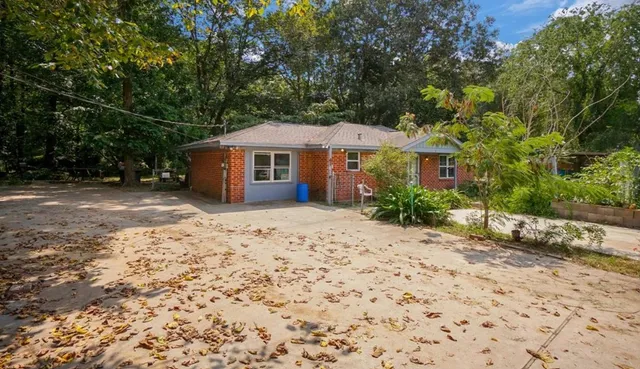 a front view of a house with a garden