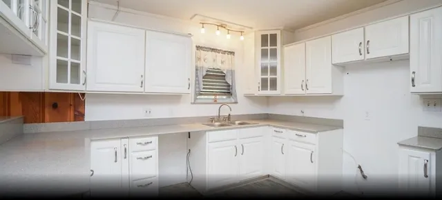 a kitchen with stainless steel appliances granite countertop a sink a stove and cabinets