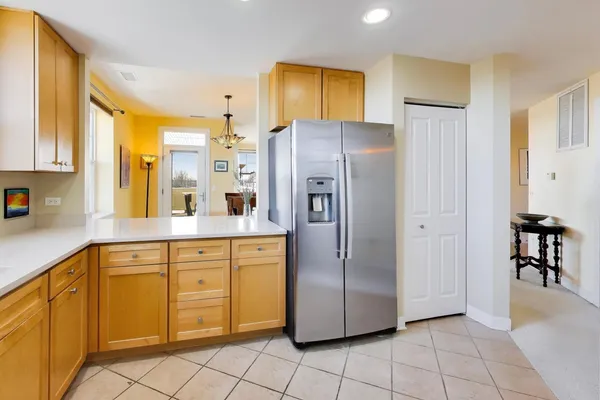 a kitchen with stainless steel appliances granite countertop a refrigerator and a sink