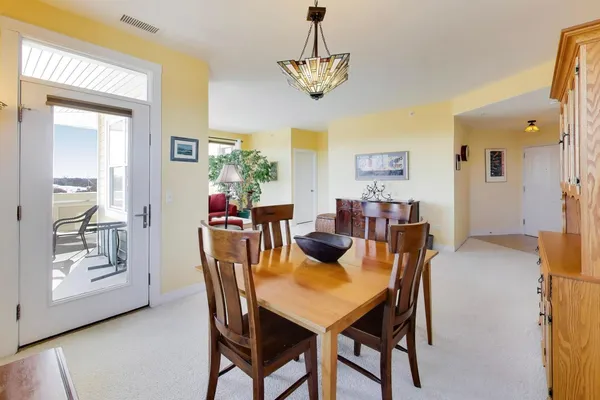 a view of a dining room with furniture and a chandelier