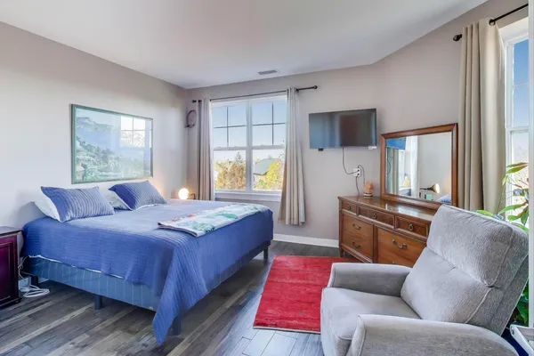 a bedroom with a bed couch and window