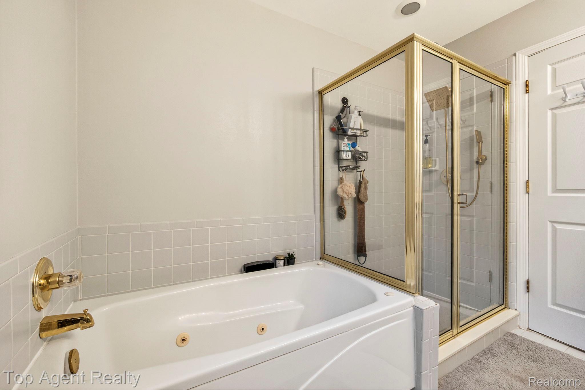 41567 Glade Road, Unit 20 Canton, MI 48187 - Photo 30 of 47 Bathroom featuring a jetted tub and a stall shower