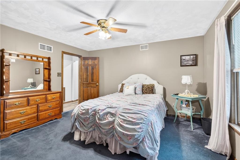 420 Kennedy Road Charleroi, PA 15022 - Photo 12 of 40 a bedroom with a bed and a chandelier