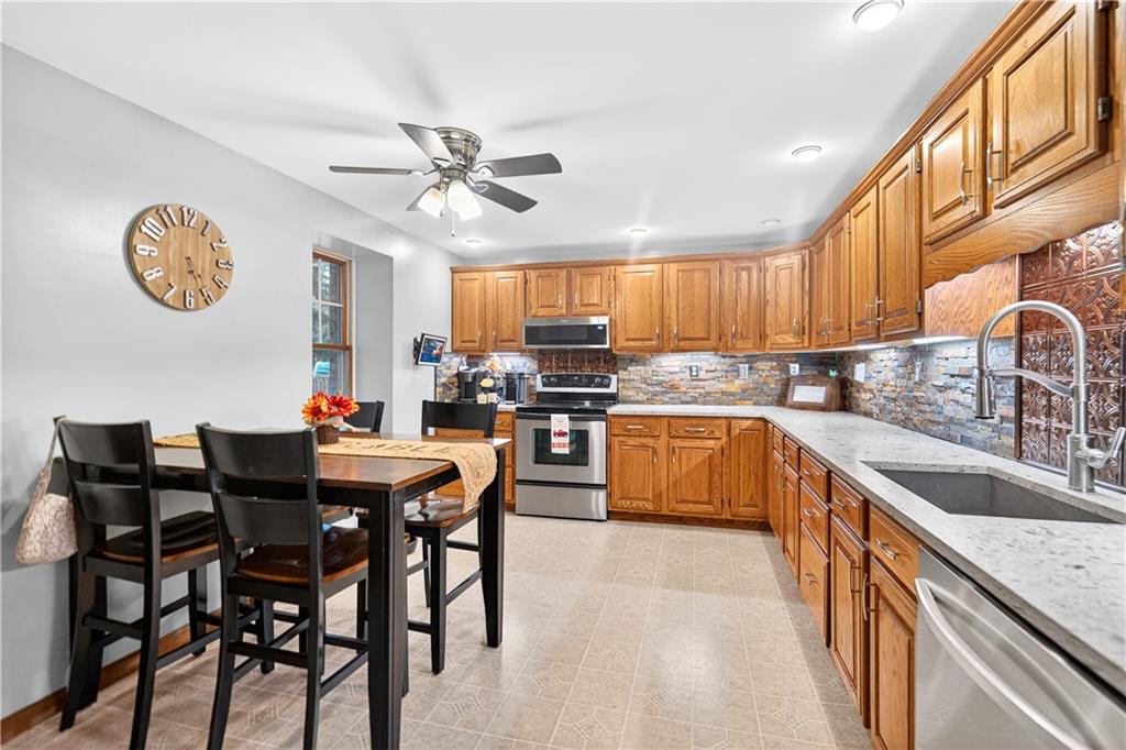 420 Kennedy Road Charleroi, PA 15022 - Photo 2 of 40 a kitchen with a dining table chairs and a refrigerator