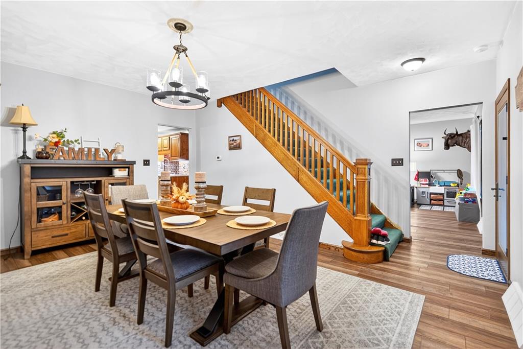 420 Kennedy Road Charleroi, PA 15022 - Photo 6 of 40 a dining room with wooden floor a chandelier a wooden table and chairs
