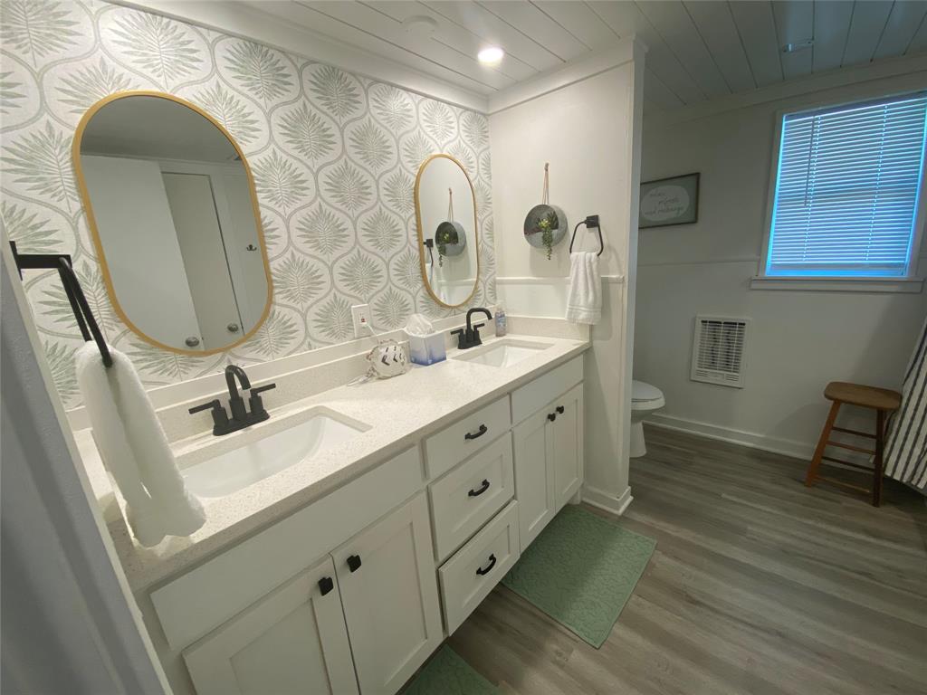 4415 Chapel Road Graham, TX 76450 - Photo 18 of 40 a bathroom with a double vanity sink mirror and