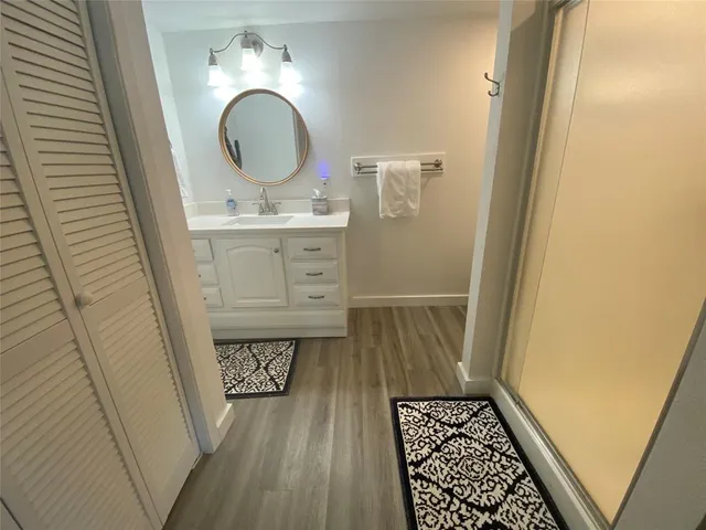 a view of a room with furniture and wooden floor