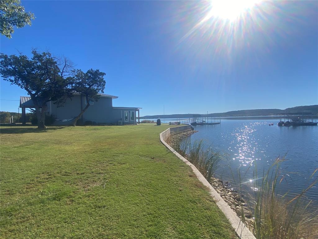 4415 Chapel Road Graham, TX 76450 - Photo 28 of 40 a view of a lake with a yard
