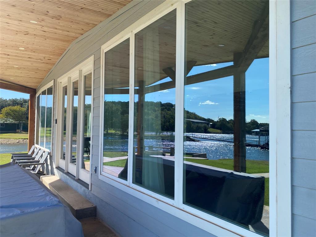 4415 Chapel Road Graham, TX 76450 - Photo 3 of 40 a view of a balcony with chair and floor to ceiling window