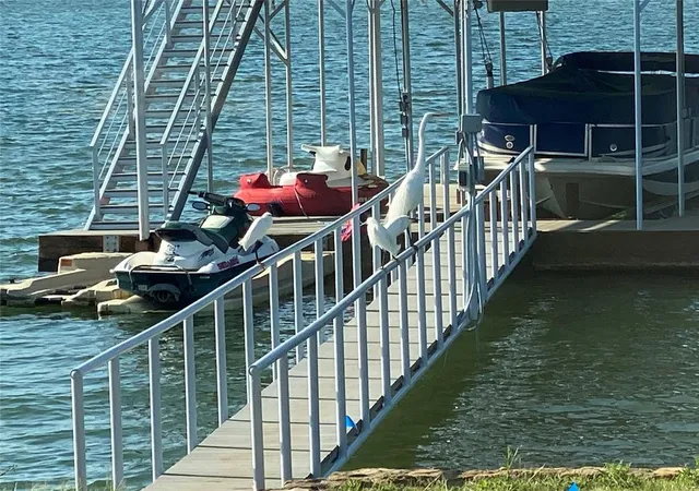 a view of swimming pool with lawn chairs and a yard