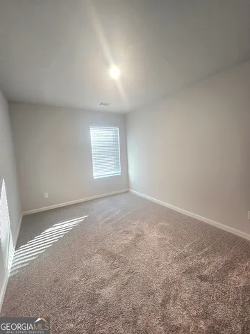 an empty room with a empty space and windows