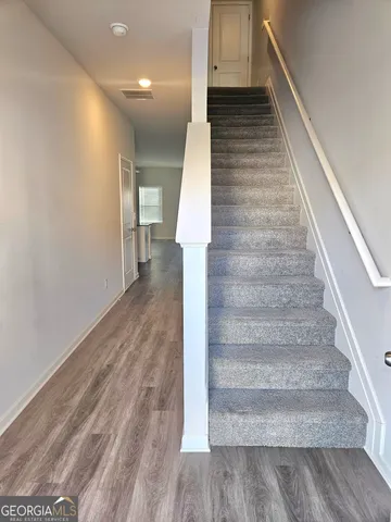 a view of entryway and hall with wooden floor