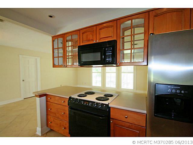 1144 Northwest Spruce Ridge Drive Stuart, FL 34994 - Photo 12 of 25 Exterior Front. Pass thru glass front cabinets for entertaining