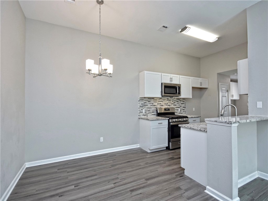 2302 Fuzz Fairway, Unit B Austin, TX 78728 - Photo 2 of 27 Gorgeous complete remodel! Granite countertops, SS appliances with glass mosaic tile backsplash. Luxury vinyl plank flooring. You will want to entertain in this Kitchen!