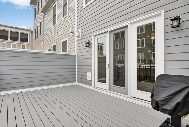 a view of a hallway with wooden floor and entryway