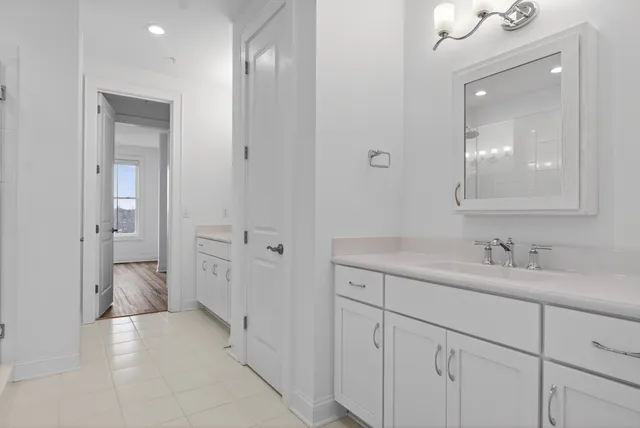 a close view of a sink and dishwasher in a white cabinet