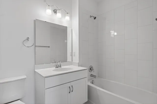 a view of a hallway with wooden floor and entryway